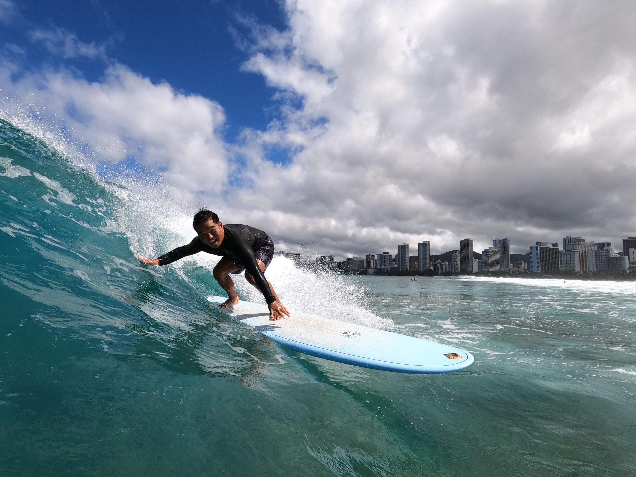 Surfer On A Wave With Blue Ocean & Sky Img