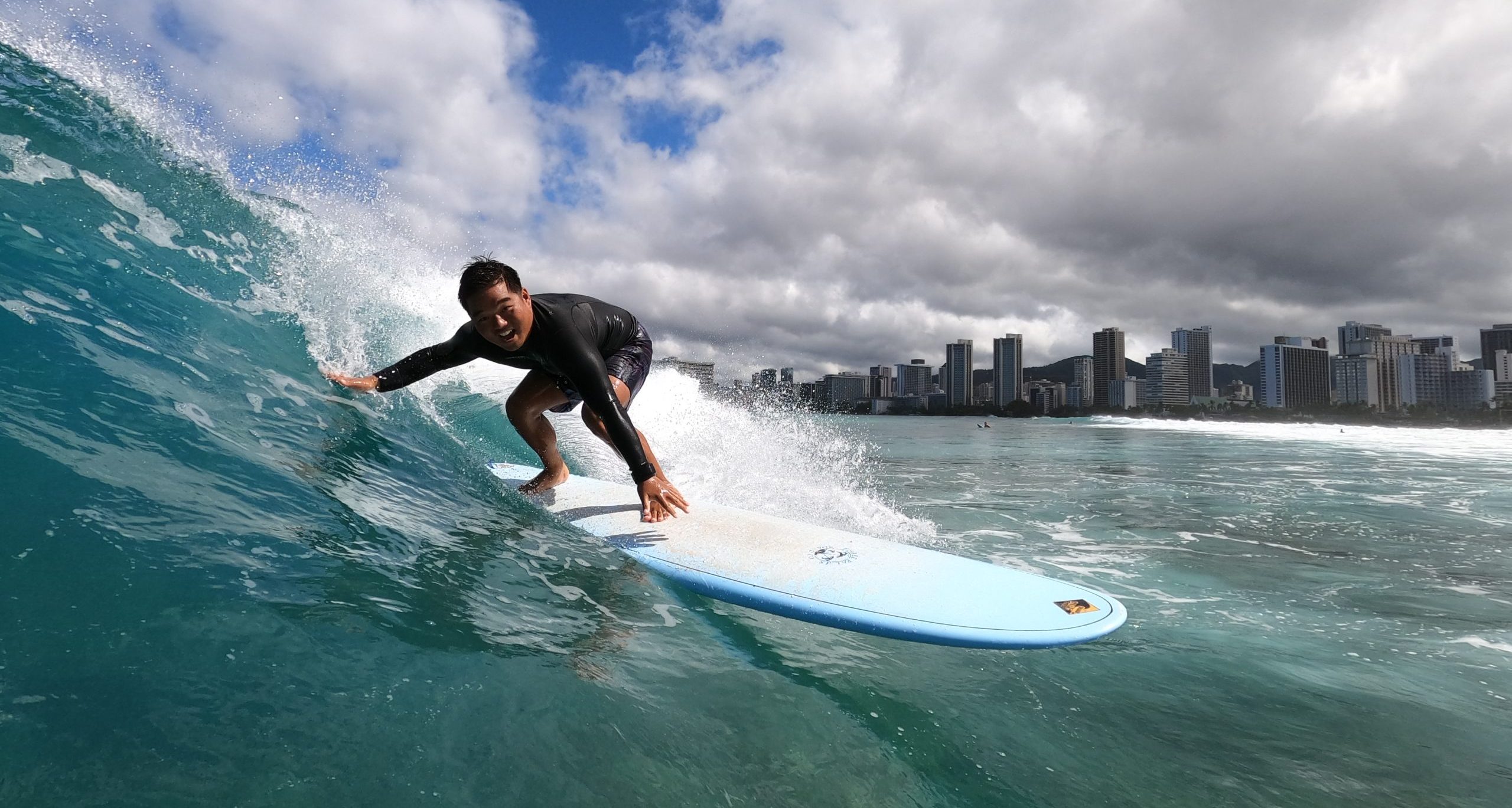 Surfer On A Wave With Blue Ocean & Sky Img