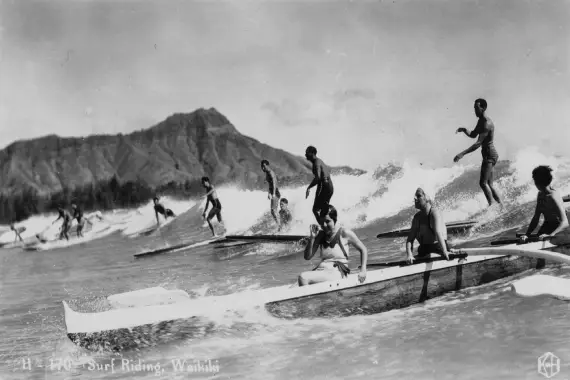 Surfers Paddling Through Waves Img