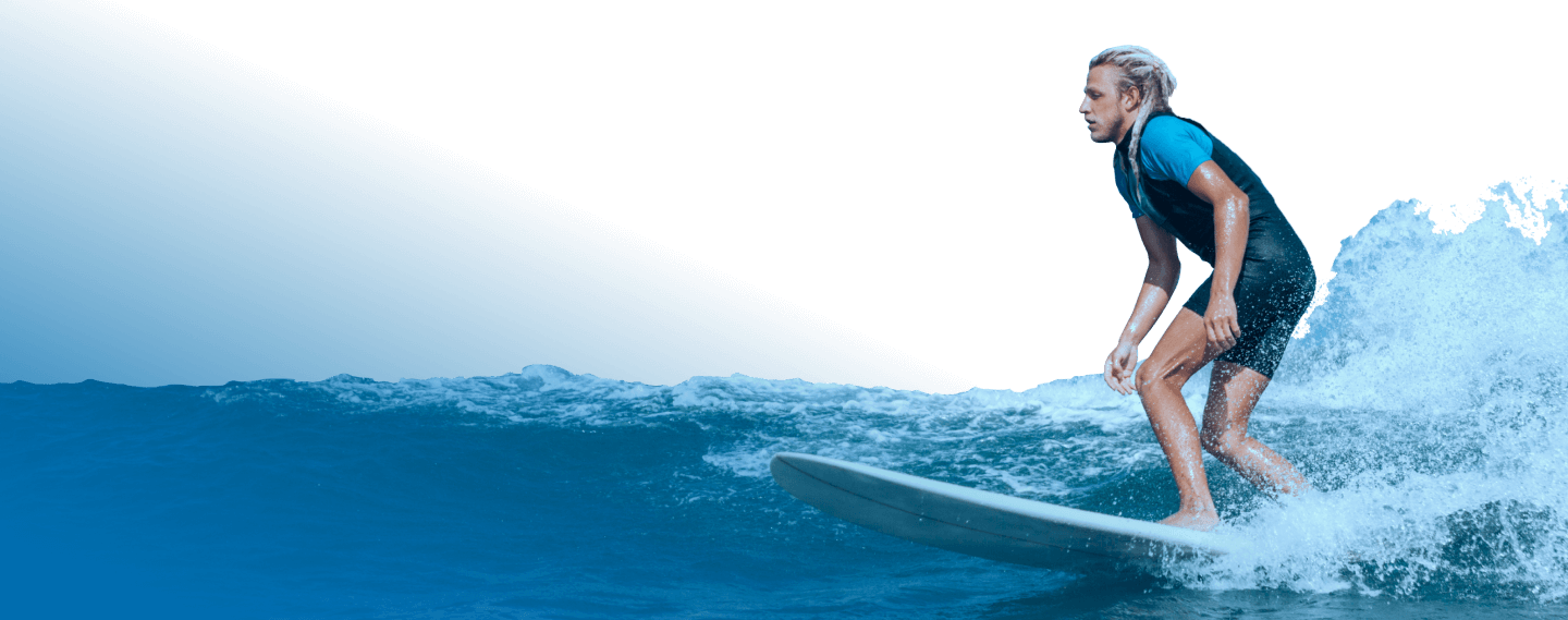 Surfer Riding A Wave In Wetsuit Img